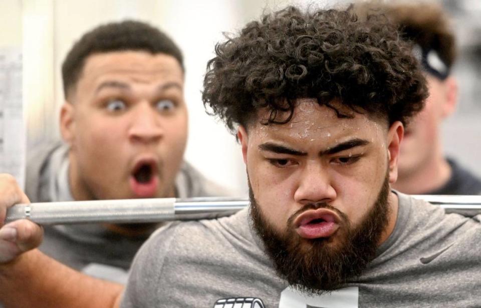 Penn State offensive lineman Vega Ioane is cheered on by teammate Nick Dawkins as he lifts during a winter workout on Thursday, Feb. 29, 2024. Abby Drey/adrey@centredaily.com