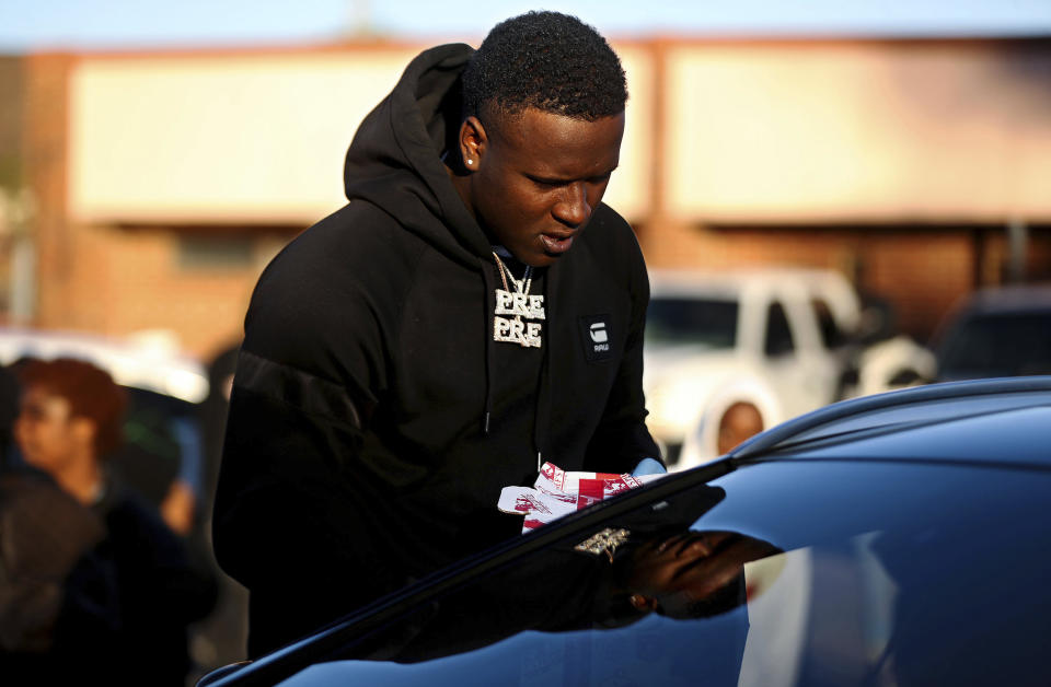 Terrance Baker, who performs as Paper Route Woo, hands out a turkey at St. James Missionary Baptist Church in south Memphis, Tenn., Friday, Nov. 19, 2021. The event was planned by local rapper Young Dolph before he was killed two days prior. (Patrick Lantrip/Daily Memphian via AP)