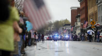 Community members line the streets in downtown Adams, Mass., to pay their respects as the funeral procession for Capitol Police Officer William "Billy" Evans leaves St. Stanislaus Kotska Church after his funeral, Thursday, April 15, 2021. Evans was killed this month when a driver struck him and another officer at a barricade outside the Senate. (Stephanie Zollshan/The Berkshire Eagle via AP)