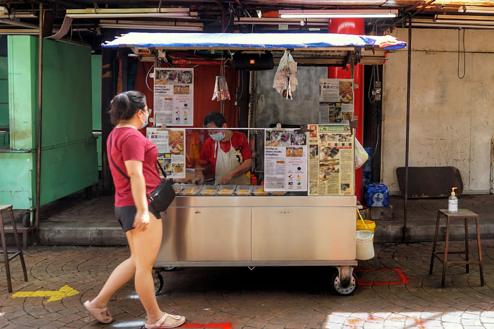 A street food vendor is pictured at her stall on Petaling Street during the conditional movement control order October 18, 2020. — Picture by Ahmad Zamzahuri