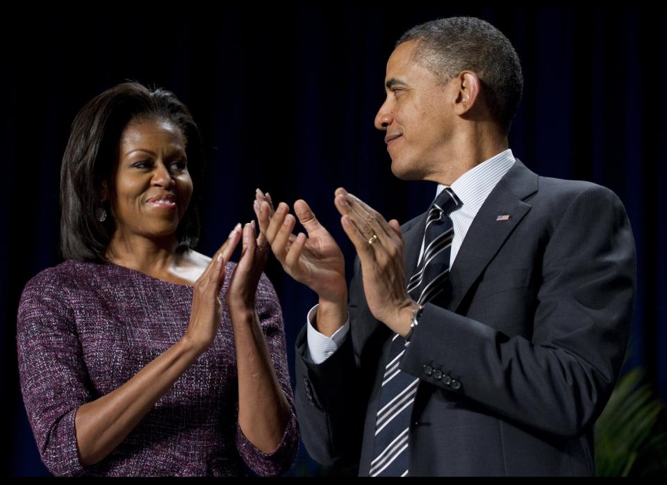 US President Barack Obama applauds alongside First Lady Michelle Obama during the National Prayer Breakfast at the Washington Hilton in Washington, DC, February 2, 2012. AFP PHOTO / Saul LOEB (Photo credit should read SAUL LOEB/AFP/Getty Images)