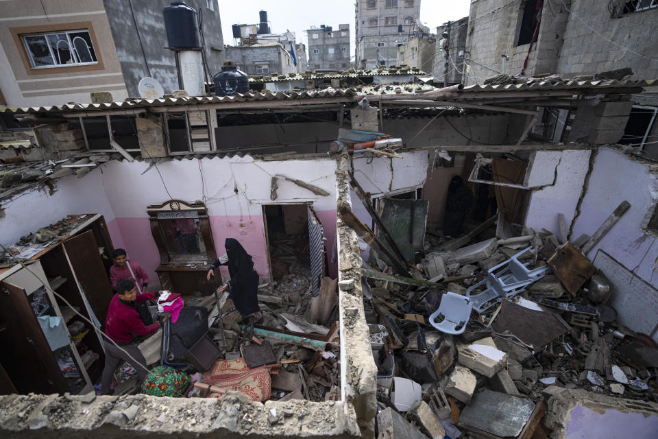 Palestinians inspect the damage to a house after an Israeli airstrike in Rafah, southern Gaza Strip, Tuesday, March 19, 2024. (AP Photo/Fatima Shbair)