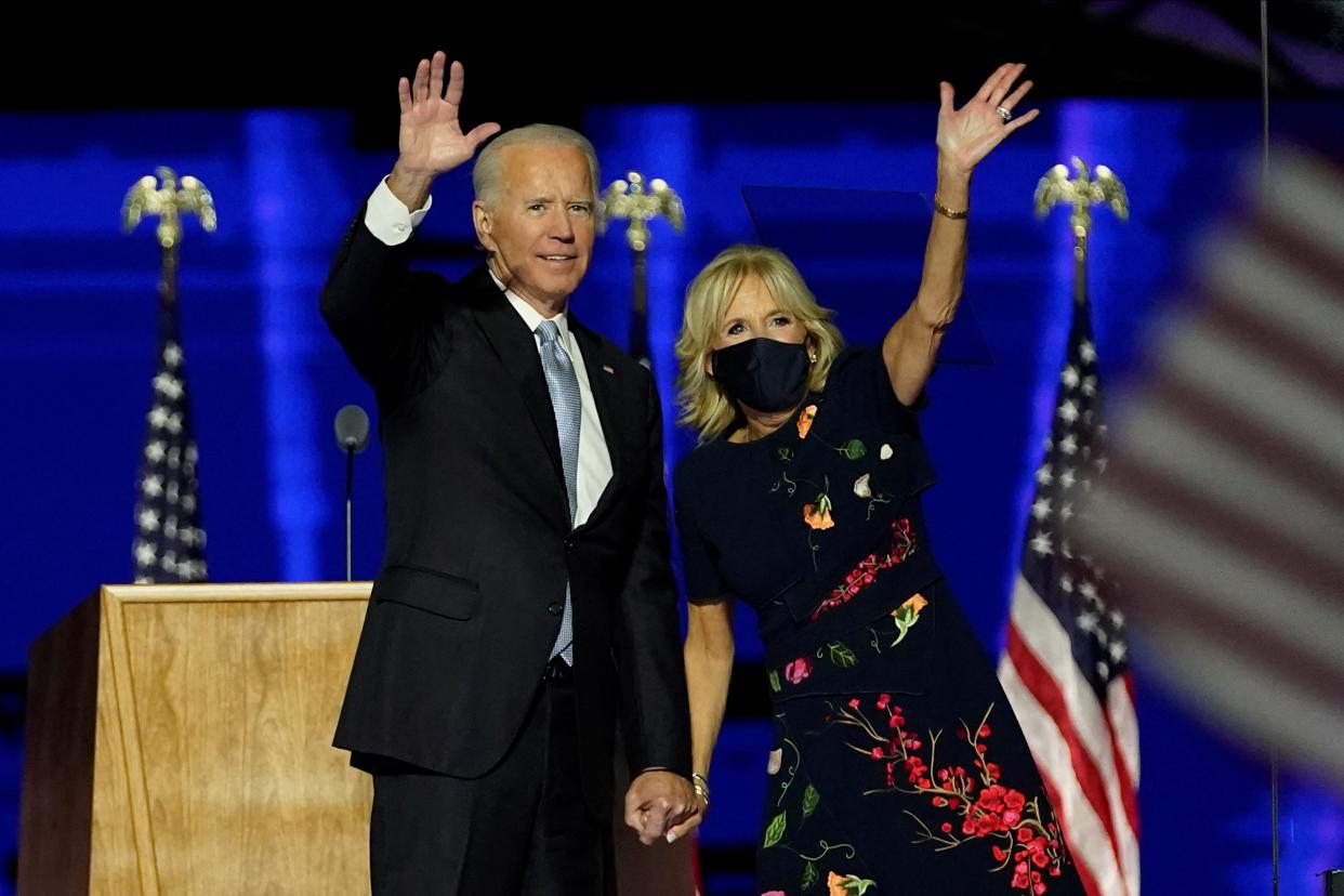 TOPSHOT - US President-elect Joe Biden with his wife Jill Biden salute the crowd on stage after delivering remarks in Wilmington, Delaware, on November 7, 2020, and being declared the winner of the US presidential election. (Photo by Andrew Harnik / POOL / AFP) (Photo by ANDREW HARNIK/POOL/AFP via Getty Images)