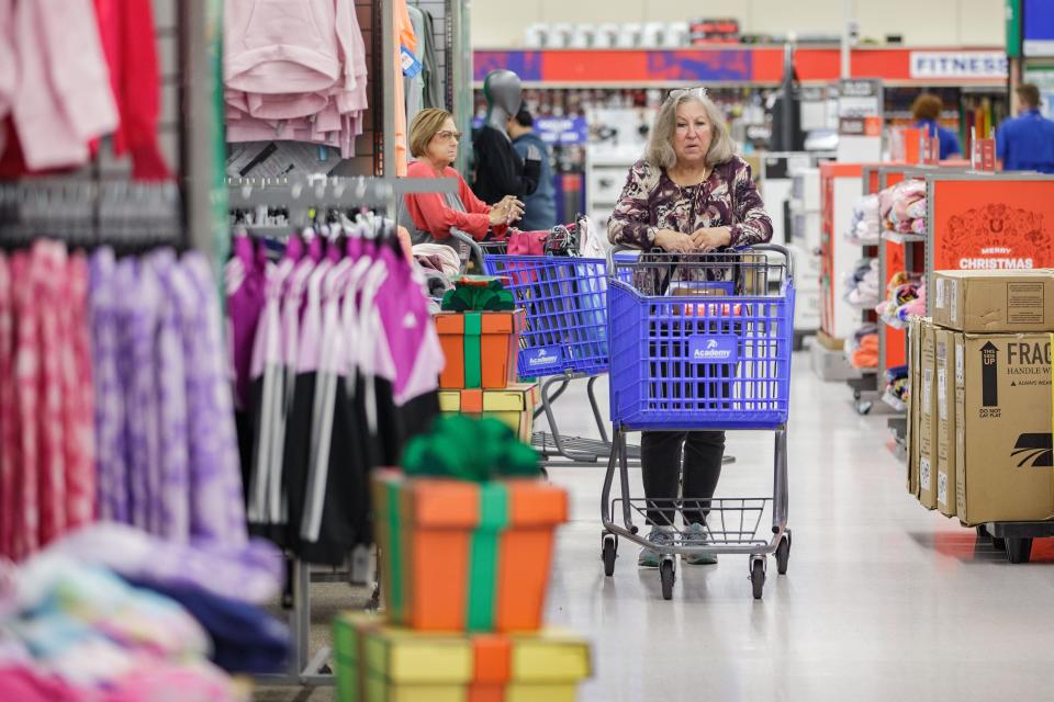 Customers look for deals while shopping at Academy Sports + Outdoors during the Black Friday shopping event Friday, Nov. 26, 2021.