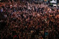 Demonstrators show the three-fingered salute during a rally in Bangkok