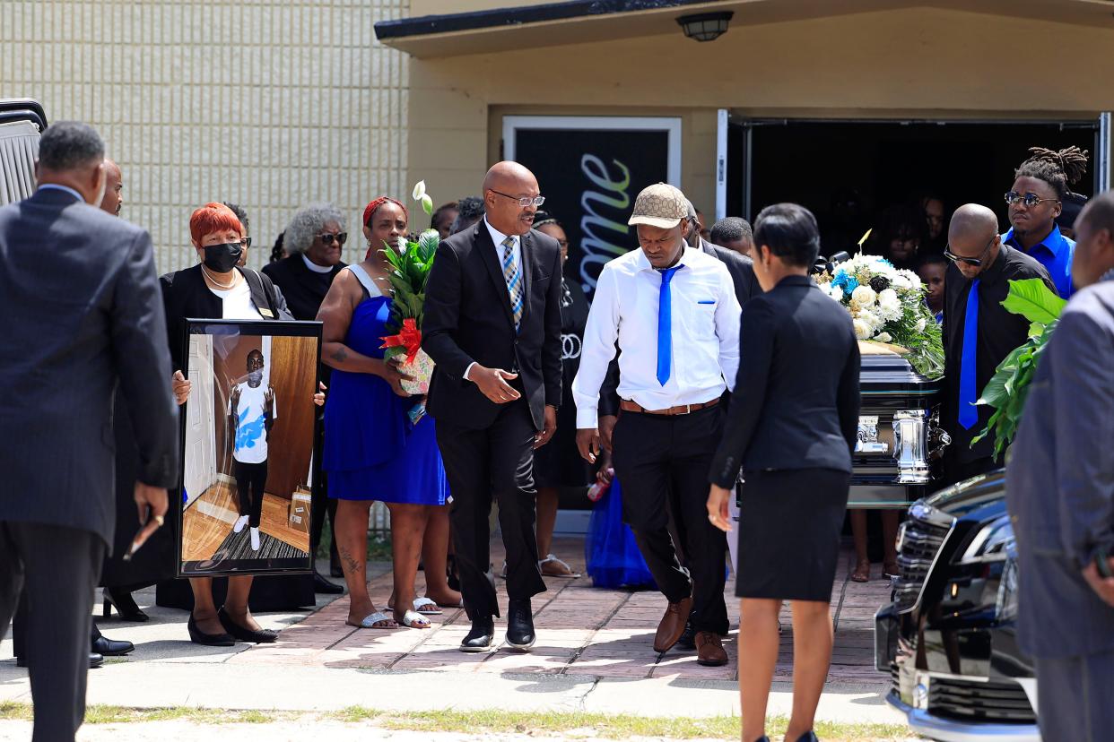 Pallbearers carry a casket to a Hearse as Carrol Gibbs, left, blue dress holding peace lilies, looks on, during the funeral services for her son, 29-year-old Jerrald De’Shaun Gallion, Saturday, Sept. 9, 2023 at St. Paul Missionary Baptist Church of Jacksonville in Jacksonville, Fla. Gallion was one of three victims killed – Anolt Joseph "AJ" Laguerre Jr., 19, and Angela Michelle Carr, 52, being the others – in a racially-motivated shooting at the Dollar General on Kings Road on Aug. 26, 2023.