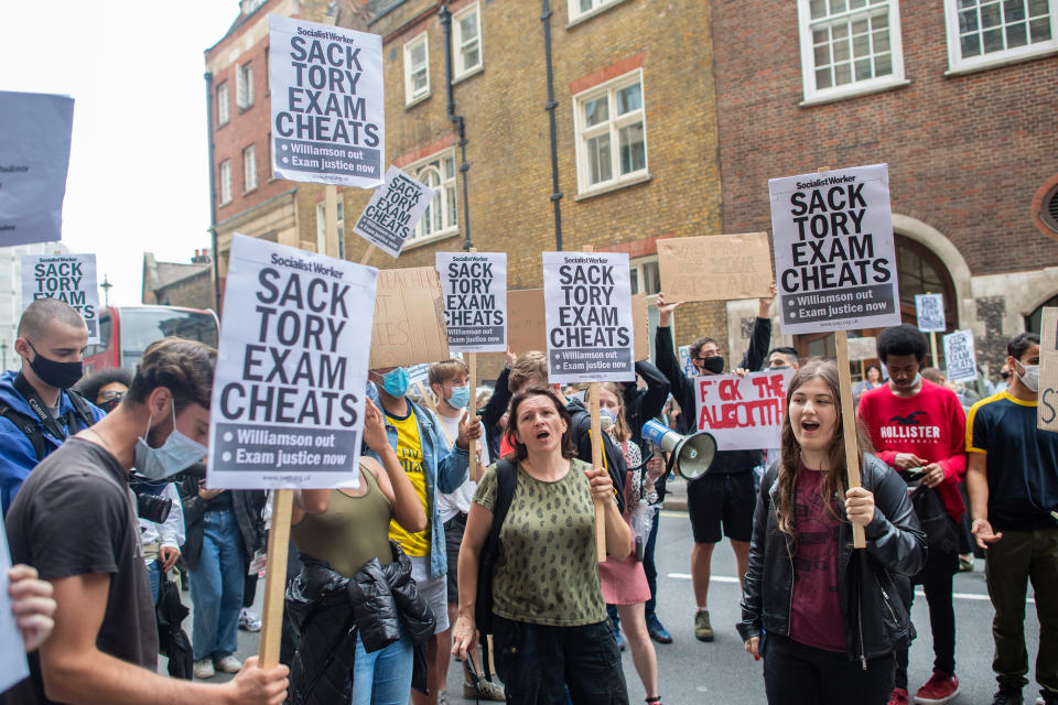 People take part in a protest marching from Downing Street to the Department of Education in Westminster, London, over the government's handling of A-level results. Thousands of pupils across England have expressed their disappointment at having their results downgraded after exams were cancelled due to coronavirus. Picture date: Friday August 14, 2020. Photo credit should read: Matt Crossick/Empics