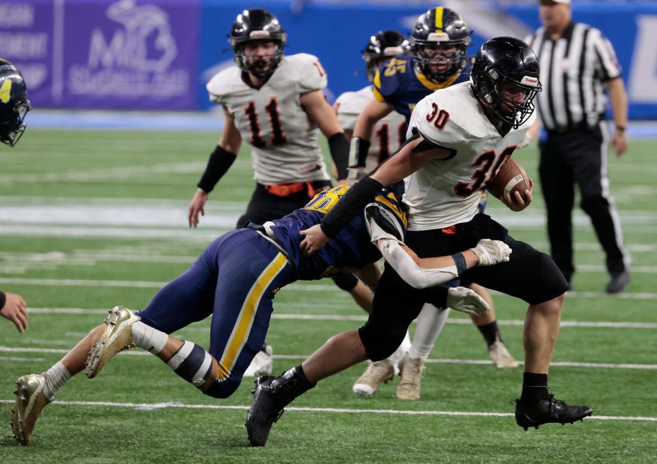 Ubly's Seth Maurer runs through the defense of Ottawa Lake Whiteford during the Division 8 football state championship game on Saturday, Nov. 25, 2023, at Ford Field.