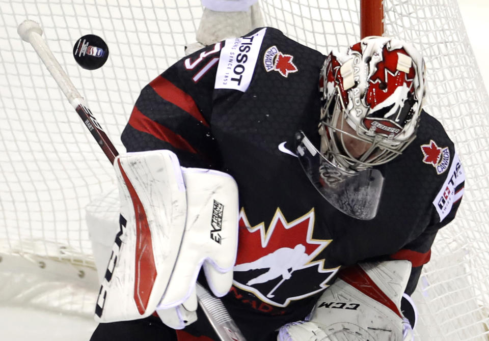 Canada's goaltender Carter Hart makes a save during the Ice Hockey World Championships group A match between Canada and Denmark at the Steel Arena in Kosice, Slovakia, Monday, May 20, 2019. (AP Photo/Petr David Josek)