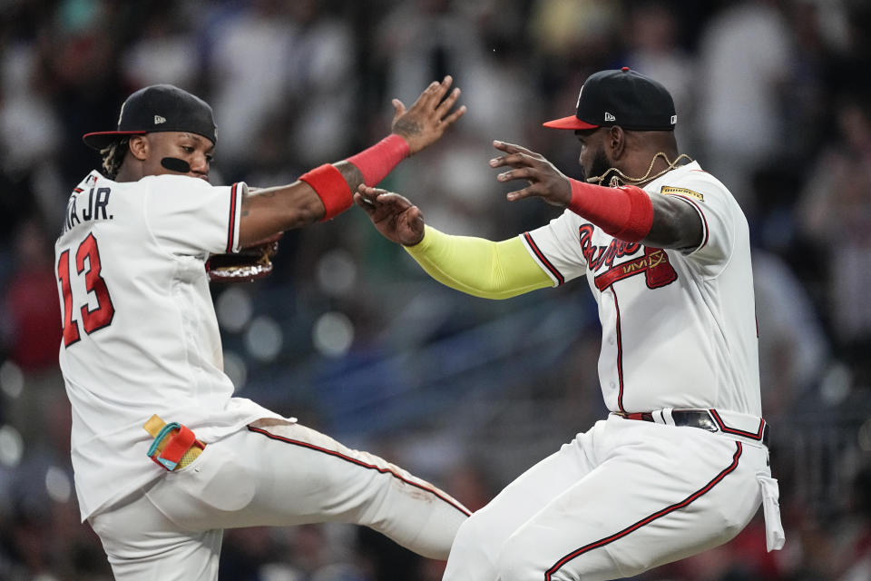 Atlanta Braves' Ronald Acuña Jr., left, and Marcell Ozuna celebrate the team's win over the New York Yankees a baseball game Wednesday, Aug. 16, 2023, in Atlanta. (AP Photo/John Bazemore)