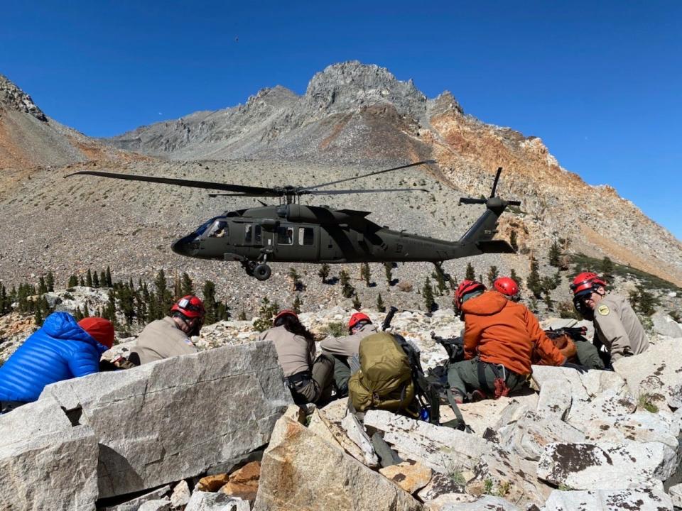 A helicopter and a search and rescue team are pictured as they scour California's Split Mountain for experienced hiker Quang Than, who disappeared on Aug. 21, 2022, and hasn't been seen since.