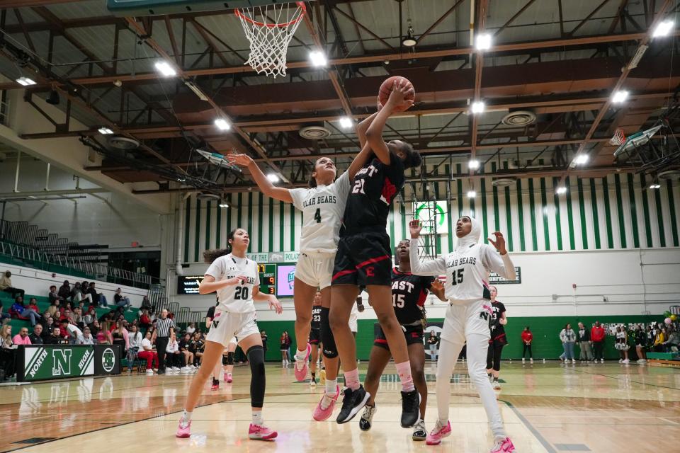 East's Jaleeyah Hardy, center right, attempts to score past North's Haylie Weinheimer on Tuesday at North High School in Des Moines.