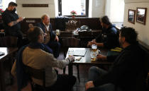 Men enjoy a beer at a pub in Prague, Czech Republic, Thursday, Dec. 3, 2020. A sign of normalcy has returned to the Czech Republic ahead of the Christmas period after the government eased some of its most restrictive measures imposed to contain the recent massive surge of coronavirus infections. On Thursday all stores, shopping malls, restaurants, bars and hotels were allowed to reopen. (AP Photo/Petr David Josek)