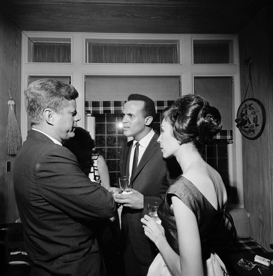 President John F. Kennedy speaks with singer Harry Belafonte and Julie Belafonte.