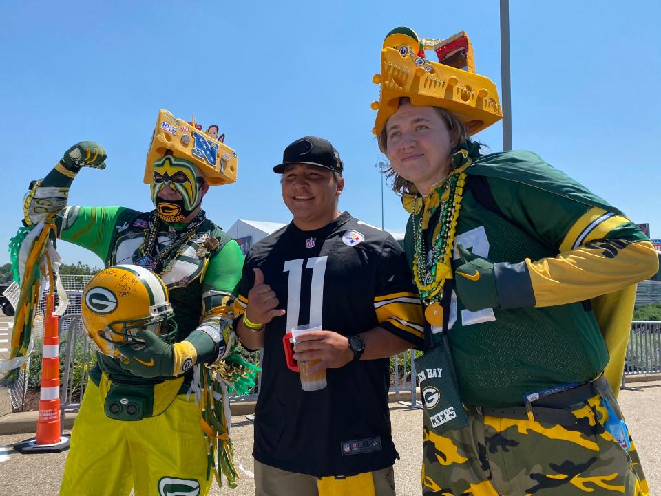 Chris Nelson, left, of Canton, and Tim Parsons, of Louisville, right, pose in 2021 with a Pittsburgh Steelers fan at the Hall of Fame Fun Fest and Beer Fest during the Pro Football Hall of Fame Enshrinement Festival.