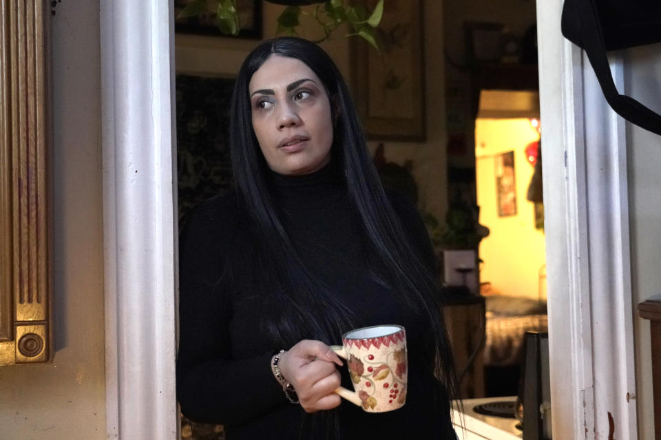 Isabel Miranda drinks coffee, Wednesday, March 10, 2021, in her rental apartment where she lives with her partner and two sons, in Haverhill, Mass. The Biden administration is extending a federal moratorium on evictions of tenants who've fallen behind on rent during the coronavirus pandemic. Miranda, who has an eviction hearing next month from her apartment, said she had mixed feelings about the extension. She worries that the courts and the landlord will not recognize the federal moratorium but also recognizes it gives her time to come up with the nearly $10,000 in back rent. (AP Photo/Elise Amendola)