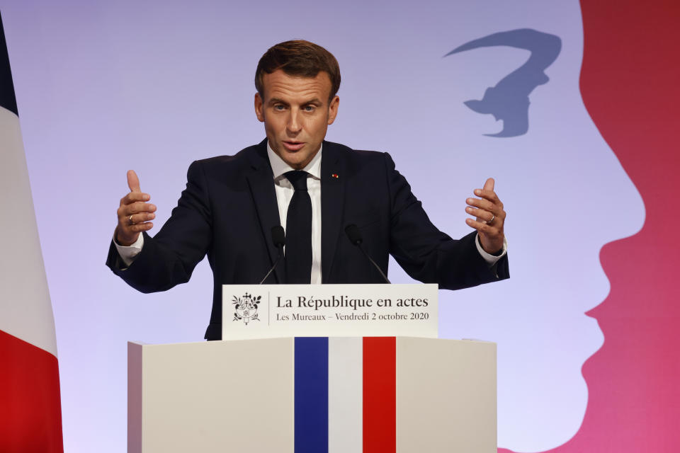 French President Emmanuel Macron delivers a speech to present his strategy to fight separatism, Friday Oct. 2, 2020 in Les Mureaux, outside Paris. President Emmanuel Macron, trying to rid France of what authorities say is a "parallel society" of radical Muslims thriving outside the values of the nation, is laying the groundwork Friday for a proposed law aimed at helping remedy the phenomenon. (Ludovic Marin / POOL via AP)