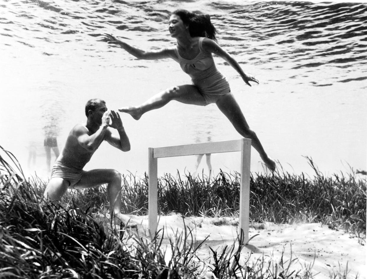 This image, circa 1950, shows a model in a bathing suit jumping a hurdle. Photographs like this, showing everyday scenes underwater, ran in newspapers nationwide helping to increase the popularity of Silver Springs.