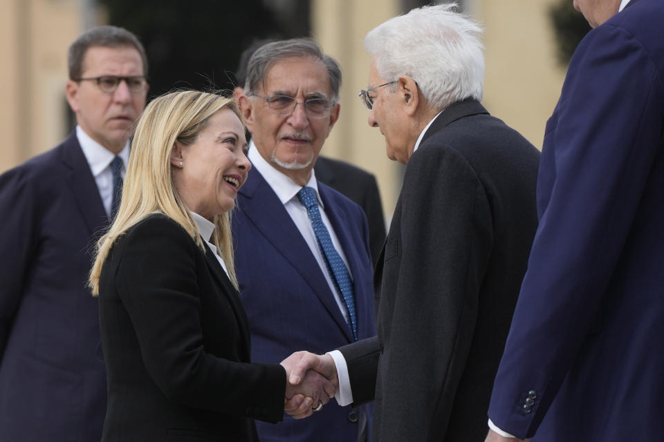 Italian President Sergio Mattarella, right, shakes hand with Italian Premier Giorgia Meloni at the unknown soldier monument during a ceremony to mark Italy's Liberation day, in Rome, Tuesday, April 25, 2023. The anniversary marks the day in 1945 when the Italian resistance movement proclaimed an insurgency as the Allies were pushing German forces out of the peninsula. (AP Photo/Gregorio Borgia)