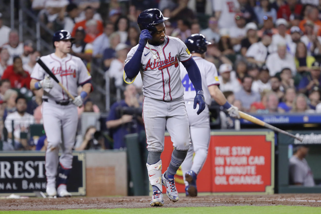 Ozzie Albies limps to first base after getting hit by a pitch in the foot Monday night. (AP Photo/Michael Wyke)