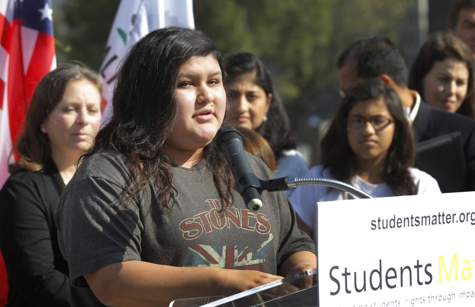 Raylene Monterroza takes questions from the media, as she is joined by eight other California public school students who are suing the state to abolish its laws on teacher tenure, seniority and other protections, during a news conference outside the Los Angeles Superior Court Monday, Jan. 27, 2014 in Los Angeles. Their case Vergara v. California is the latest battle in a growing nationwide challenge to union-backed protections for teachers. (AP Photo/Nick Ut)