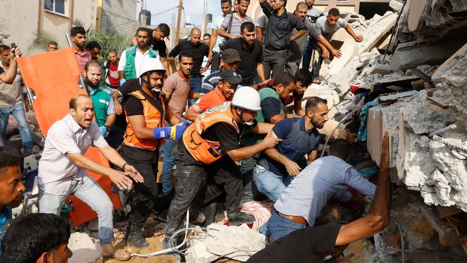 Palestinians search for casualties under the rubble of a house destroyed in Israeli strikes in Khan Younis, in the southern Gaza Strip.    - Ibraheem Abu Mustafa/Reuters