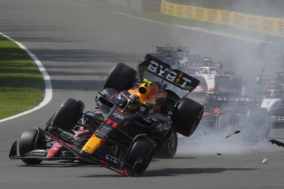 Red Bull driver Sergio Perez of Mexico, front, crashes with Ferrari driver Charles Leclerc of Monaco at the start of the Formula One Mexico Grand Prix auto race at the Hermanos Rodriguez racetrack in Mexico City, Sunday, Oct. 29, 2023. (AP Photo/Fernando Llano)