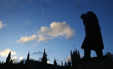 The statue of Britain's former Prime Minister Winston Churchill is silhouetted in front of the Houses of Parliament in London, January 30, 2015. REUTERS/Eddie Keogh