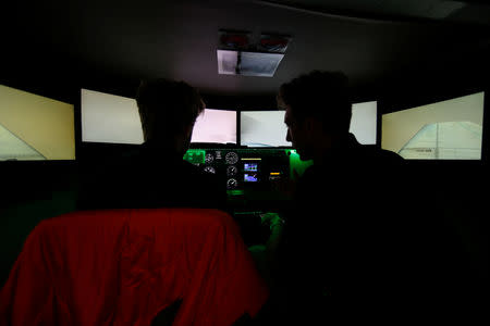 Flight instructor Jake Bacon works with student pilot Devon Stillwell in a flight simulator at Coast Flight Training in San Diego, California, U.S., January 15, 2019. Picture taken January 15, 2019. REUTERS/Mike Blake