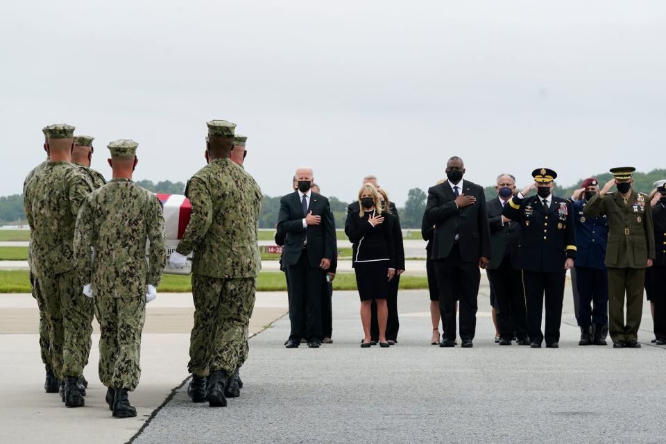 President Joe Biden and first lady Jill Biden witness in August 2021 a Navy carry team move a transfer case containing the remains of a corpsman who died in an attack at Afghanistan's Kabul airport.