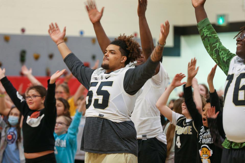 Purdue Boilermaker football freshman offensive lineman Malachi Preciado leads students as everyone dances along to YMCA during Edgelea Elementary School's ILEARN prep rally, on Friday, April 7, 2023, in Lafayette, Ind.