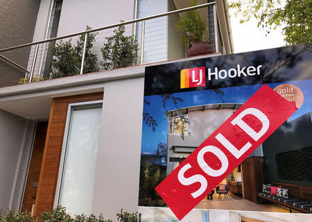 A sold sticker is attached to a real estate agent's sign outside the front of a residential property in central Sydney, Australia, November 22, 2016. REUTERS/David Gray