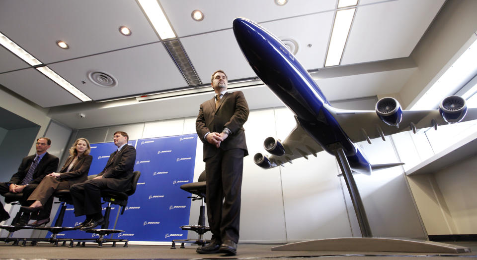 Boeing 747 communications manager Jim Proulx, right, looks over at a model of the first Boeing 747-8 Intercontinental jet during a news conference about the first delivery of the aircraft Tuesday, Feb. 28, 2012, in Everett, Wash. From left are Bruce Dickinson, vice president and chief project engineer for the 747-8, Elizabeth Lund, vice president and general manager of the 747 program, and Steve Taylor, president of Boeing Business Jets. The airplane was scheduled to fly away from Paine Field there later in the day. The new 747-8 Intercontinental is expected to deliver double-digit gains in fuel efficiency over the 747-400 and provide VIP customers and passenger airlines, such as Lufthansa, with the lowest operating costs and best economics of any airplane in its class. Lufthansa is scheduled to take delivery of its first 747-8 Intercontinental early this year. (AP Photo/Elaine Thompson)