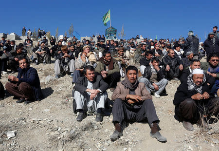 Afghan Shi'ite Muslims attend a funeral ceremony of one of the victims, who was killed during yesterday's suicide attack at Shi'ite cultural centre in Kabul, Afghanistan December 29, 2017. REUTERS/Omar Sobhani