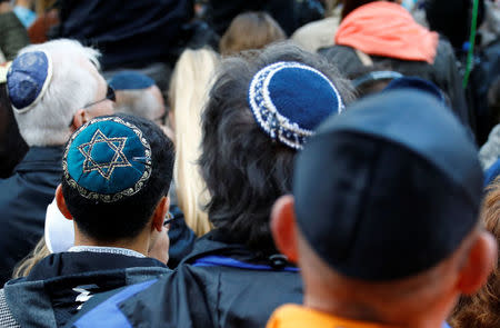 People wear kippas during a demonstration in front of a Jewish synagogue, to denounce an anti-Semitic attack on a young man wearing a kippa in the capital earlier this month, in Berlin, Germany, April 25, 2018. REUTERS/Fabrizio Bensch