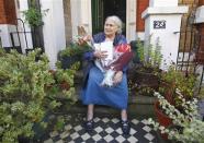 British novelist Doris Lessing is seen sitting on the doorstep of her house, after she had won the 2007 Nobel Prize for literature, in London in this October 11, 2007 file photograph. Lessing died on November 17, 2013, her publisher said on Sunday. REUTERS/Kieran Doherty/Files