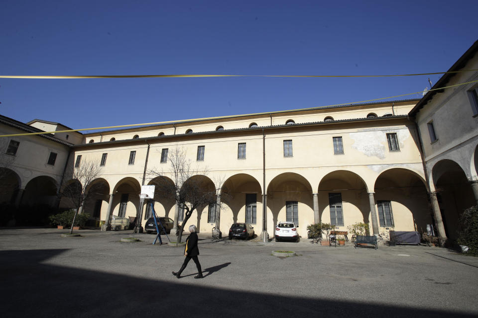 In this picture taken on Friday, Jan. 31, 2020 Yolanda Martinez Garcia walks through the courtyard of the Sant'Eustorgio's oratory church, in Milan, Italy. Her son was sexually abused by one of the priests of the Legion of Christ, a disgraced religious order. (AP Photo/Luca Bruno)