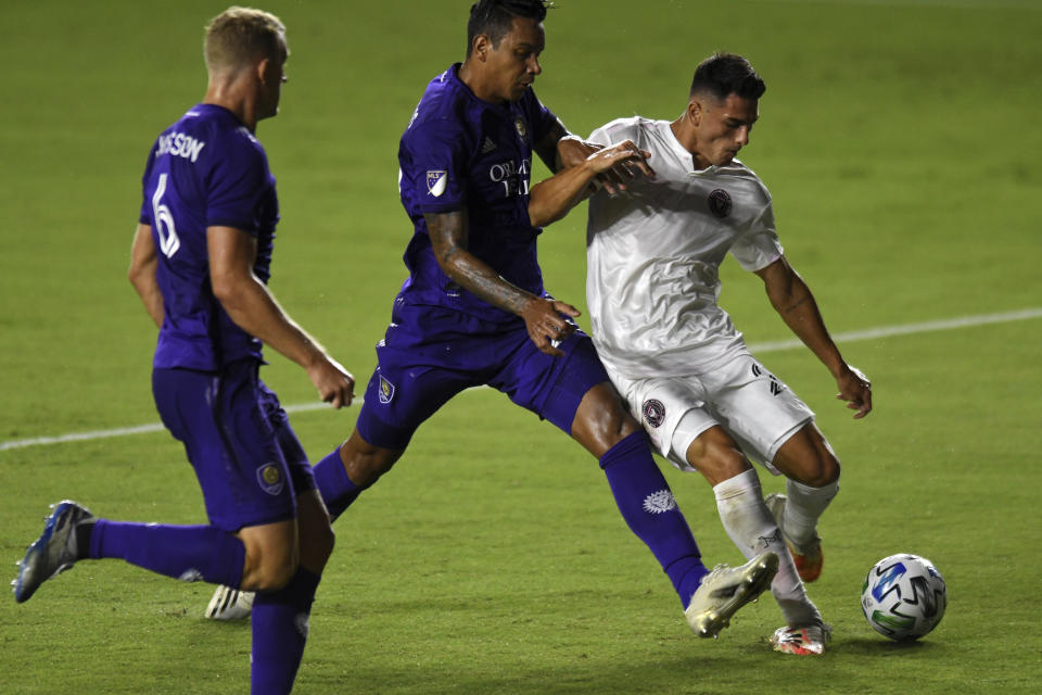 Inter Miami forward Julian Carranza shoots and scores a goal as Orlando City's Antonio Carlos, center, and Robin Jansson (6) close in during the first half of an MLS soccer match Saturday, Aug. 22, 2020, in Fort Lauderdale, Fla. (AP Photo/Jim Rassol)