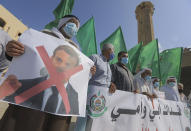 Palestinian demonstrators lift flags and placards during a rally to protest comments of French President Emmanuel Macron over Prophet Mohammed cartoons, in Deir al-Balah in the central Gaza Strip, on October 25, 2020. (Photo by MAHMUD HAMS / AFP) (Photo by MAHMUD HAMS/AFP via Getty Images)