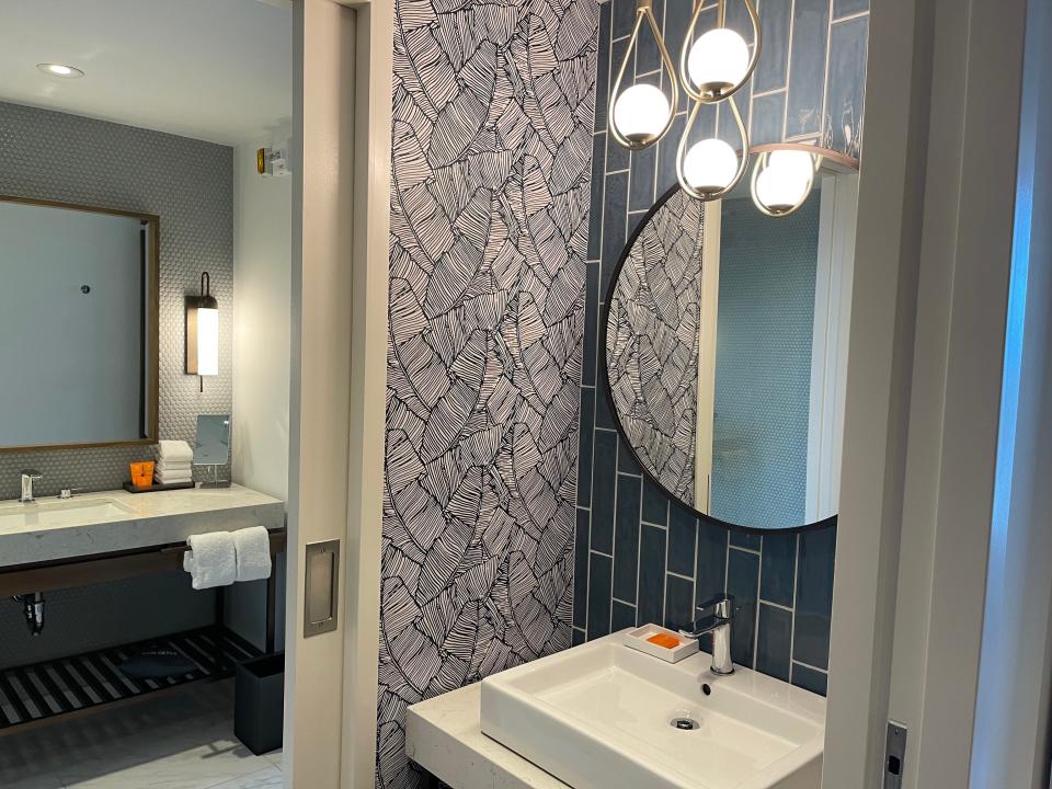 One bathroom in the suite, including a sink and large vanity.