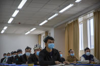 Uyghurs and other students listen to an instructor during a class at the Xinjiang Islamic Institute, as seen during a government organized visit for foreign journalists, in Urumqi in western China's Xinjiang Uyghur Autonomous Region on April 22, 2021. Under the weight of official policies, the future of Islam appears precarious in Xinjiang, a remote region facing Central Asia in China's northwest corner. Outside observers say scores of mosques have been demolished, which Beijing denies, and locals say the number of worshippers is on the decline. (AP Photo/Mark Schiefelbein)