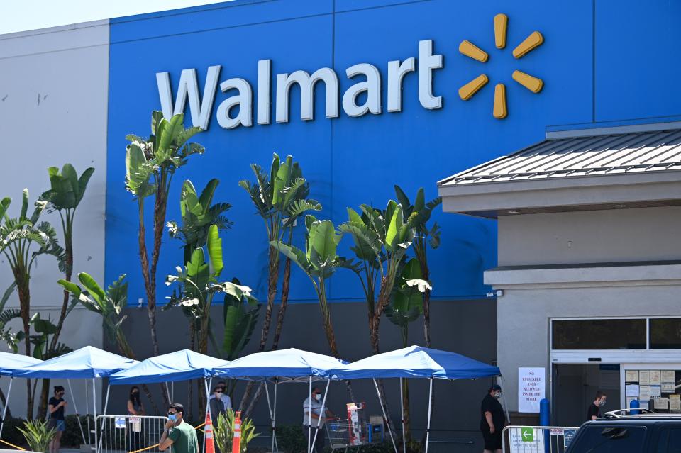 People wearing face coverings wait in line to shop at Walmart, July 22, 2020 in Burbank, California. - The country's most populous state reported a record 12,807 new coronavirus infections in the past 24 hours. (Photo by Robyn Beck / AFP) (Photo by ROBYN BECK/AFP via Getty Images)