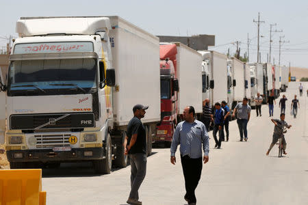 Trucks loaded with humanitarian supplies to be delivered for displaced Syrians, wait at the Jordanian city of Mafraq, near the border with Syria, Jordan July 1, 2018. REUTERS/Muhammad Hamed