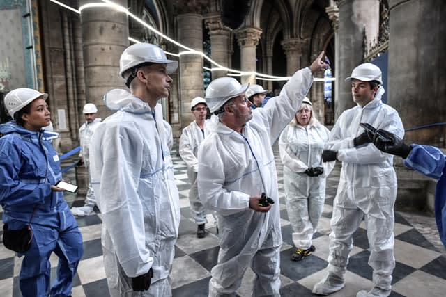 French Culture Minister Franck Riester, second left, listens to French chief architect of historical sites Philippe Villeneuve