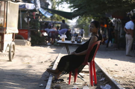 A pregnant woman rests on the railway track in front of her home as health officials collect mosquitos and larva to check for Zika virus, at a village in Phnom Penh, Cambodia February 4, 2016. REUTERS/Samrang Pring