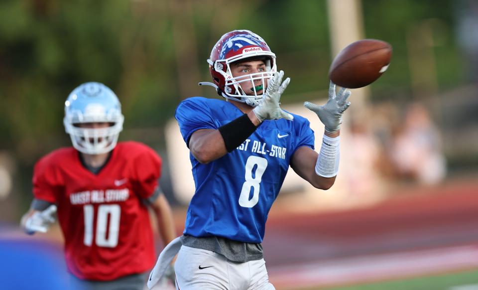 East wide receiver Devin Holbert (8) catches a pass during the East vs. West All-Star football game at Dixie Heights High School, Thursday, June 9, 2022.