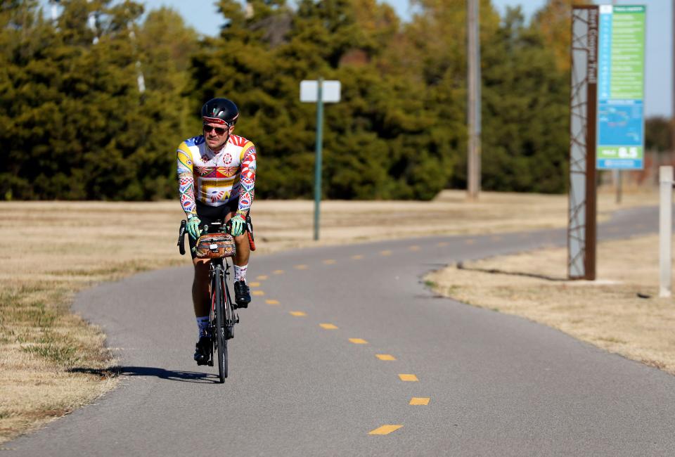 A man rides a bicycle along a trail at Lake Hefner in Oklahoma City, Tuesday, Nov. 7, 2023.