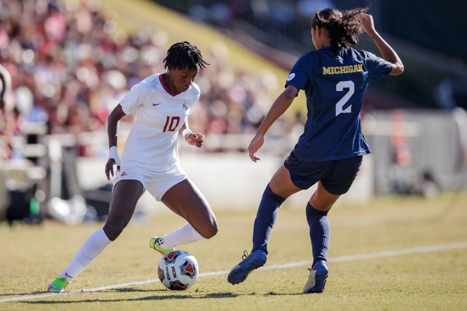 Florida State Seminoles Jody Brown (10) fakes out a defender as she moves the ball towards the goal. Florida State and Michigan remain scoreless at the half during the NCAA quarterfinals Friday, Nov. 26, 2021.