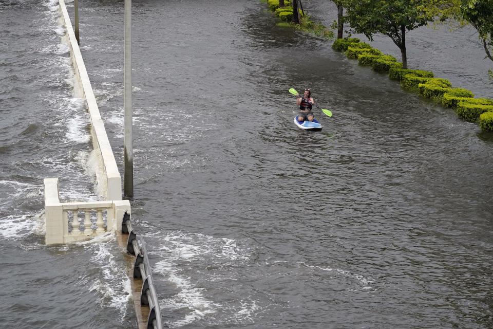 Zeke Pierce rides his paddle board down the middle of a flooded Bayshore Blvd in downtown in Tampa, Fla., Wednesday, Aug. 30, 2023. Hurricane Idalia steamed toward Florida’s Big Bend region Wednesday morning, threatening deadly storm surges and destructive winds in an area not accustomed to such pummeling. (AP Photo/Chris O'Meara)