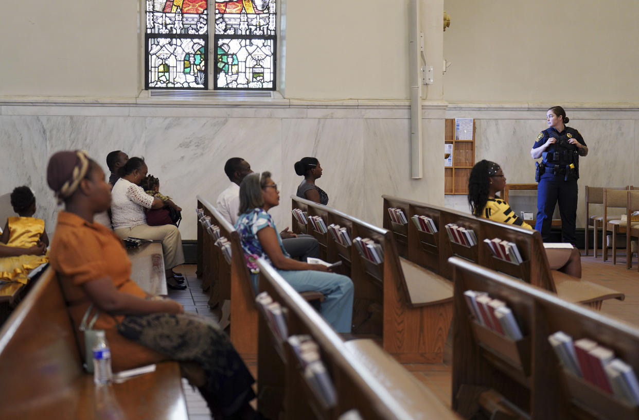 A Springfield police officer stands watch during a service at St. Raphael Catholic church, Sept. 15. (Jessie Wardarski/AP)